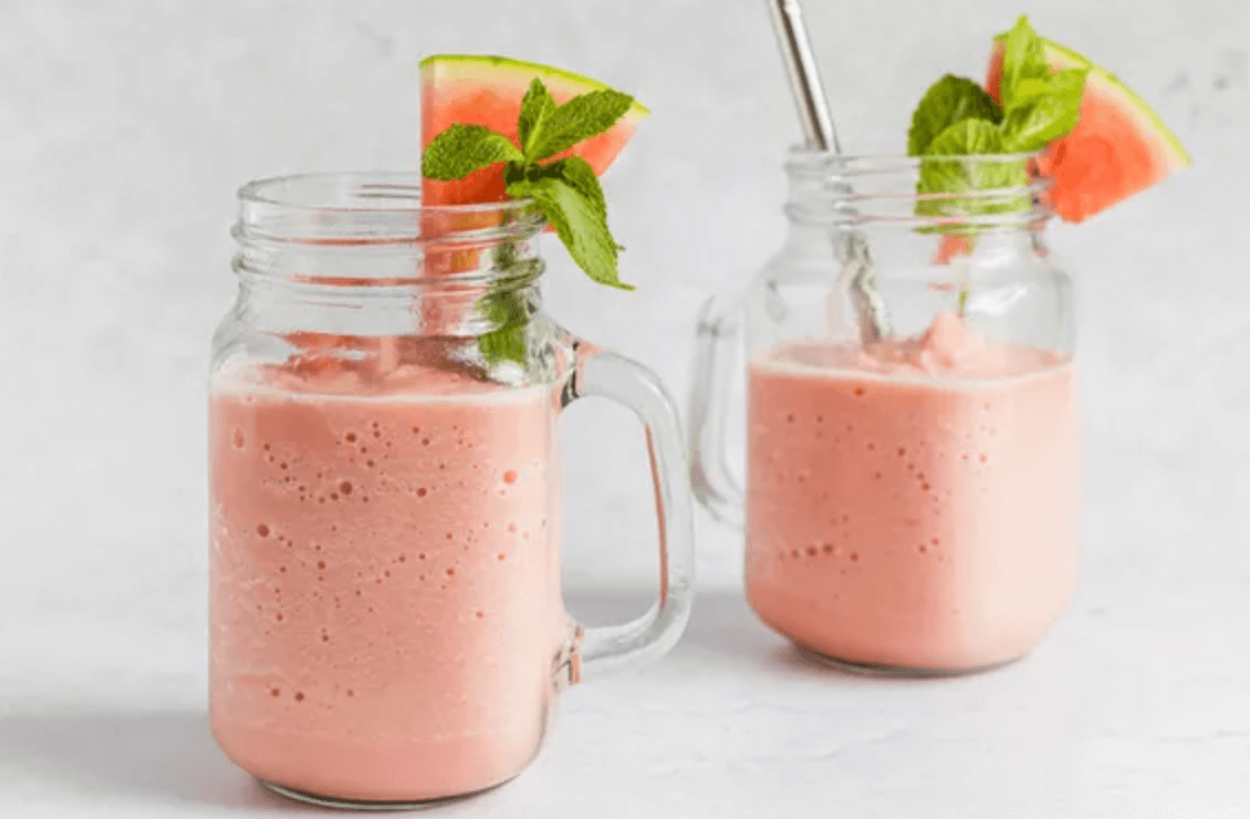 Two mason jars filled with a smoothie next to each other.